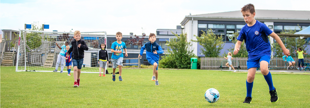 Top 6 football games for kids to include in your PE lessons 1 football boys chasing ball