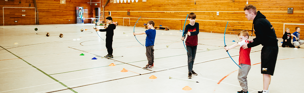 Five ways coaching impacts children's lives 1 5 ways coaching impact coach children archery 1024x314 1