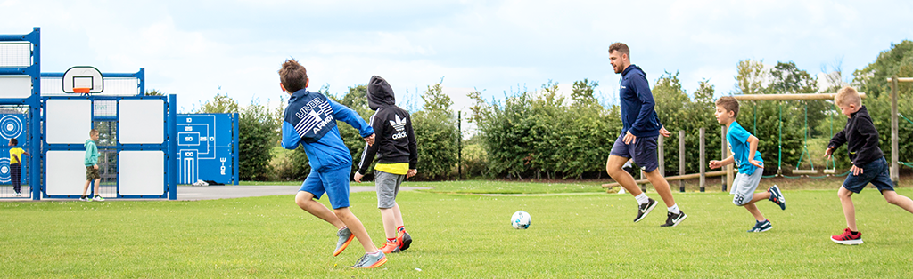 Five ways coaching impacts children's lives 2 5 ways coaching impact football children running 1024x314 1