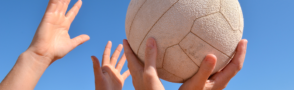 Netball 1 Netball closeup hands ball 1024x314 1