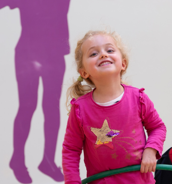 Child smiling at a Start Sporty session