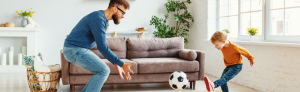 Child at home playing football inside