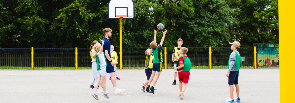 Children playing basketball at a Premier Education Holiday Camp 1