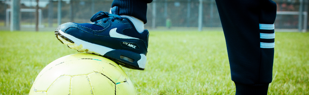 5 Football Practices Your Kids Will Enjoy at Home 2 Child with foot on football