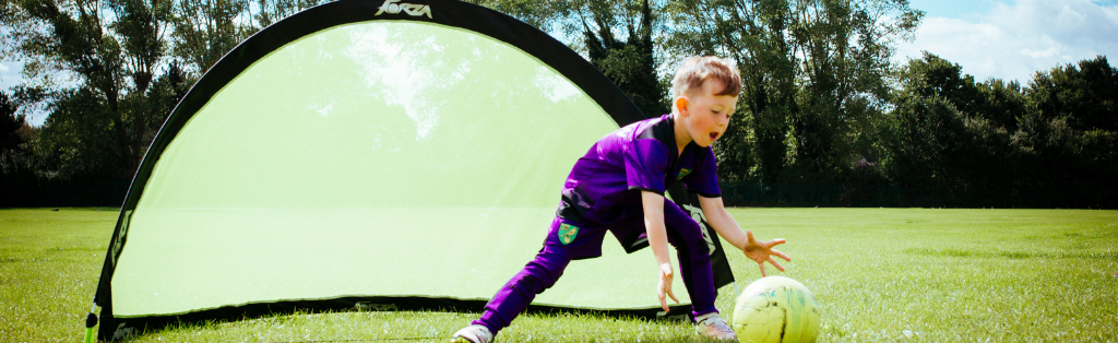 5 Football Practices Your Kids Will Enjoy at Home 3 Child with saving a goal while playing football