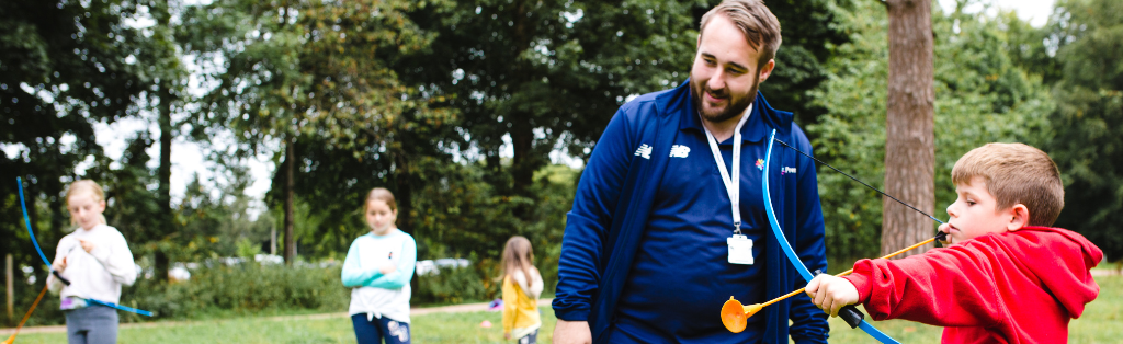 Why Archery is a Good Sport to Choose for After-Schools Clubs 1 Child receiving archery coaching from a Premier Education Activity Professional.