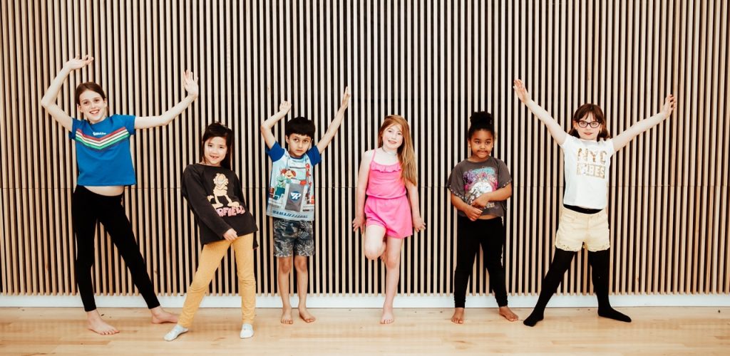 Is Dance a Sport? The Benefits for Kids 2 6 pupils standing in various dance poses