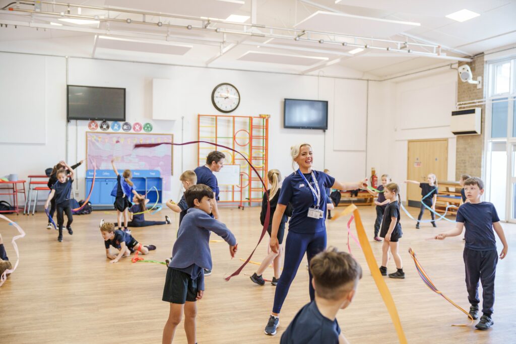 Children being taught ribbon dancing