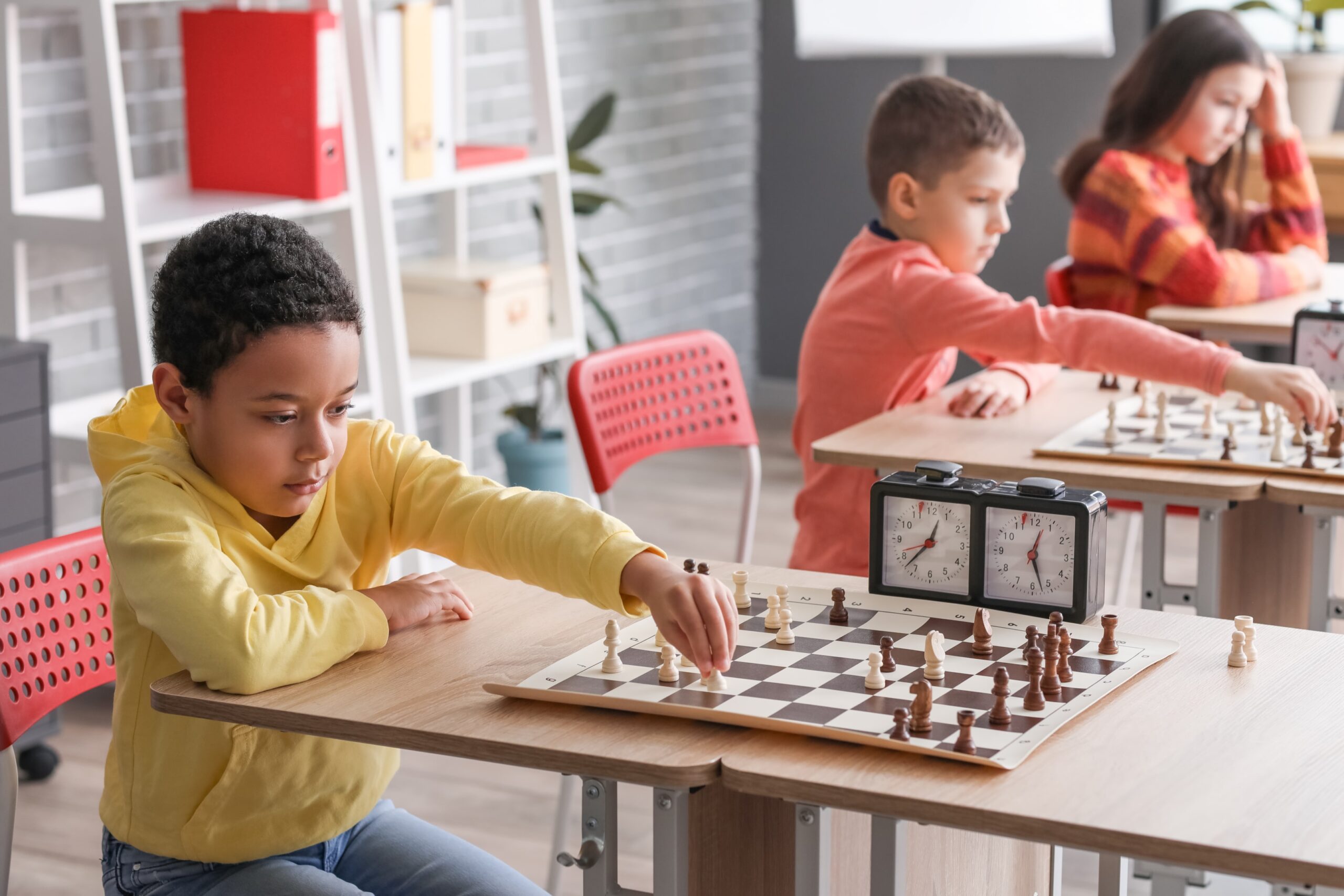 Child playing chess at an after school club