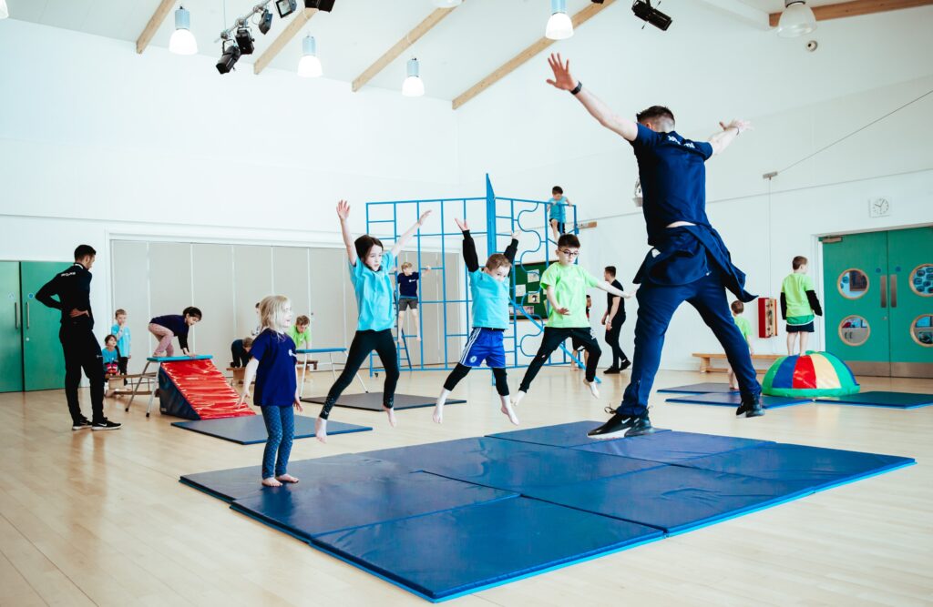 pe class featuring children jumping to build strength