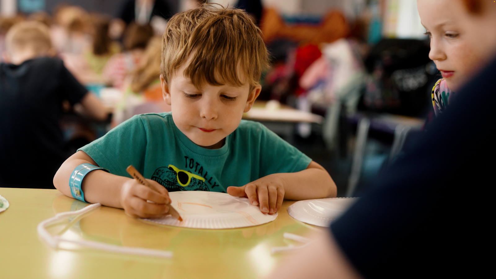 Child colouring on plates